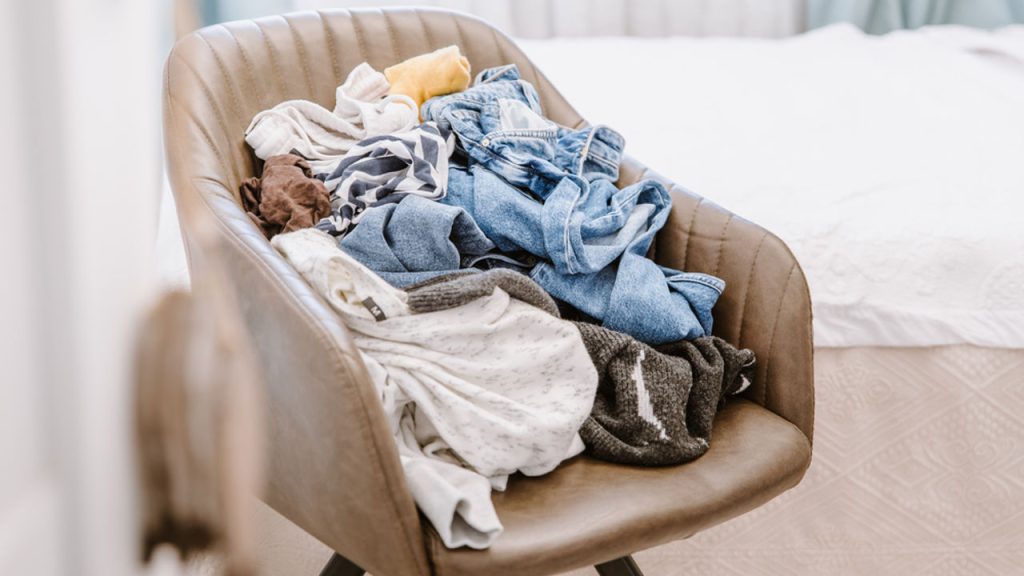 pile of laundry clothes on chair, laundry to be cleaning and folded