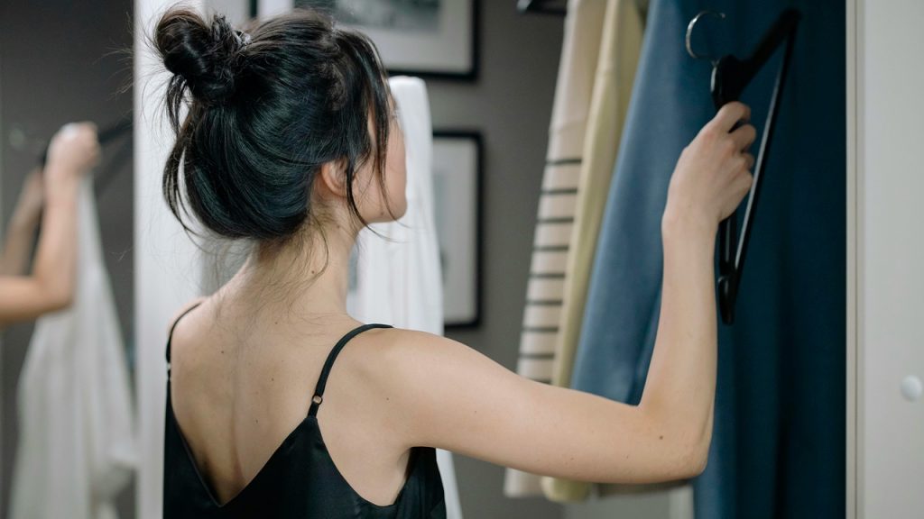 Woman organizing closet and clothes