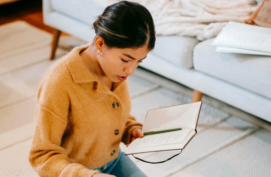 Woman thinking and taking notes during decluttering