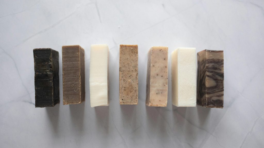 Collection of natural soaps placed on marble table