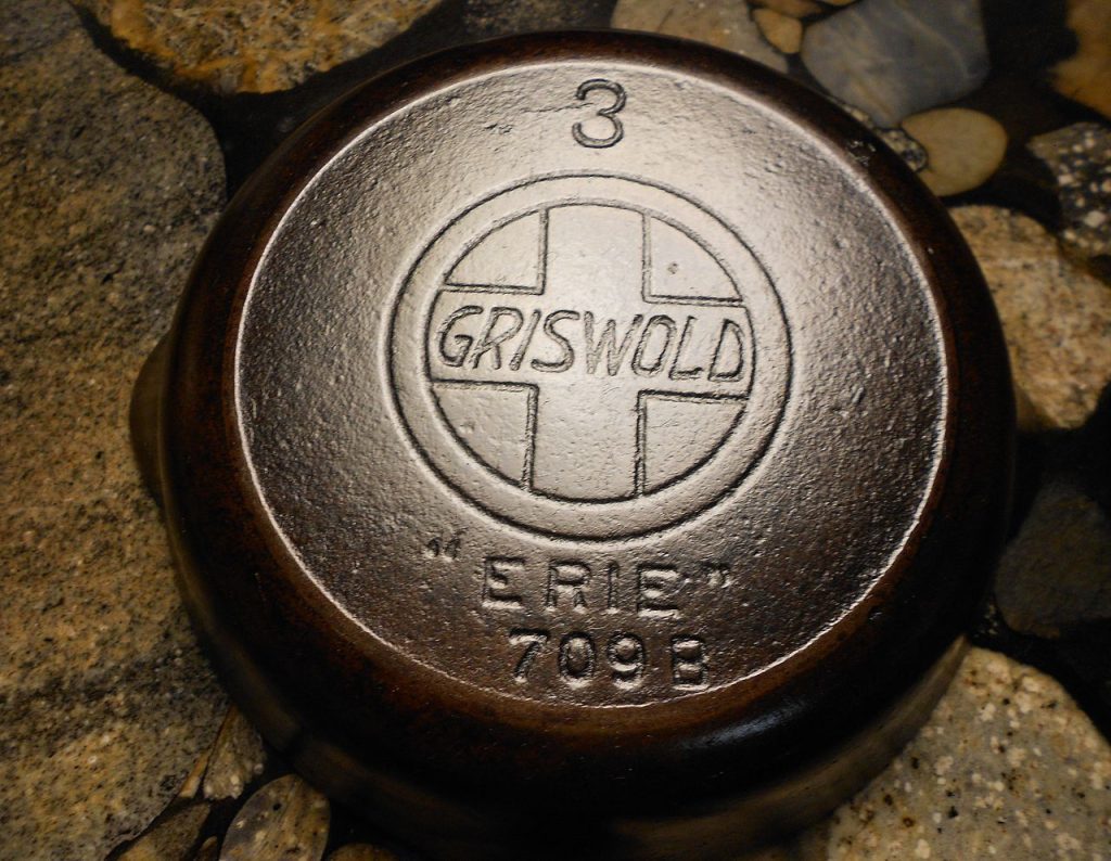 vintage Griswold cast iron skillet base marked with “3”, Griswold cross logo, “ERIE” and number 709B