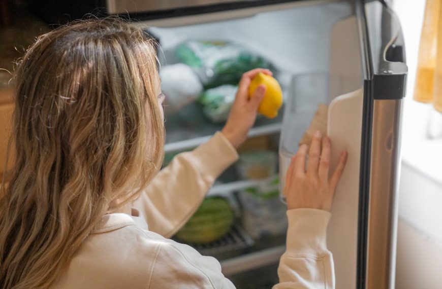 A Woman Taking a Lemon out from a Fridge