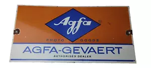 Agfa-Gevaert vintage sign, orange and blue color scheme, Agfa logo prominently displayed, authorized dealer label, classic advertising signage