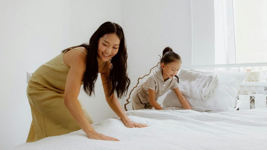 Mom and Daughter cleaning a mattress