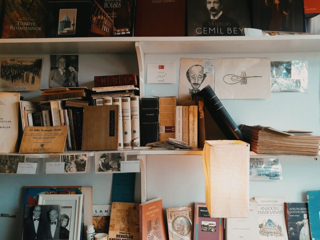 Close-up of old books on a wooden shelf, antique frame on the side, warm vintage interior, aged book covers