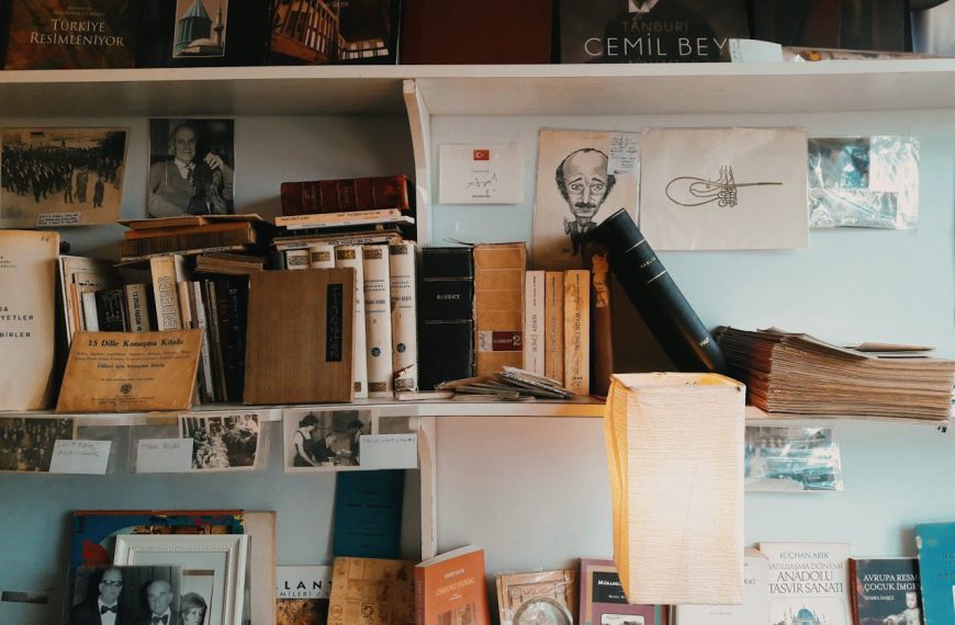 Close-up of old books on a wooden shelf, antique frame on the side, warm vintage interior, aged book covers
