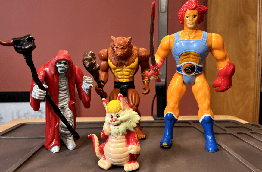 Collection of vintage action figures including ThunderCats characters and other 1980s toys displayed on shelf