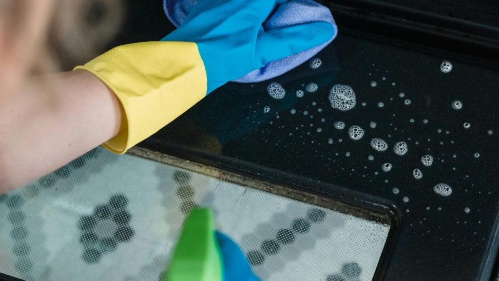 sprayed surface with visible cleaner foam or bubbles