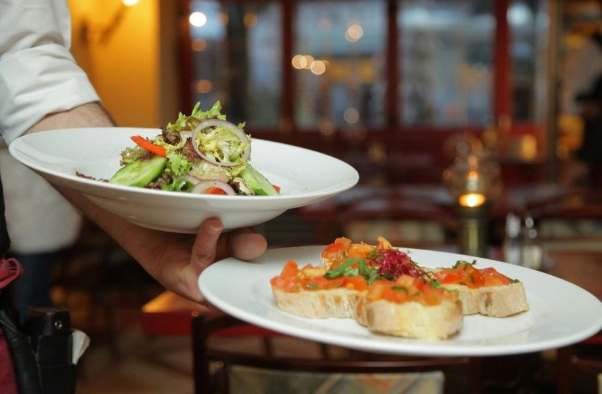 waiter serving a small complimentary appetizer