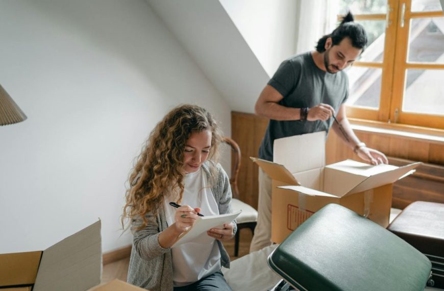 A joyful couple unpacks boxes in their modern, cozy apartment