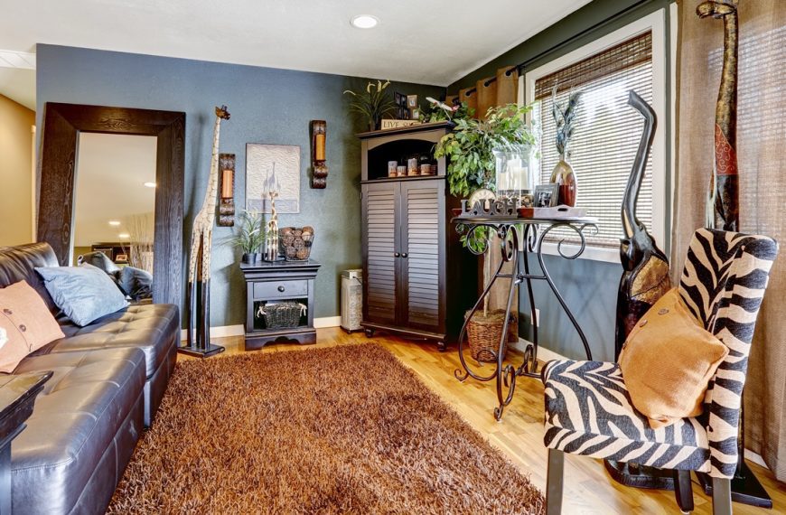 Animal decor, Cozy living room with a brown rug, blue accent wall, zebra-print chair, tall cabinet, indoor plants, and large windows