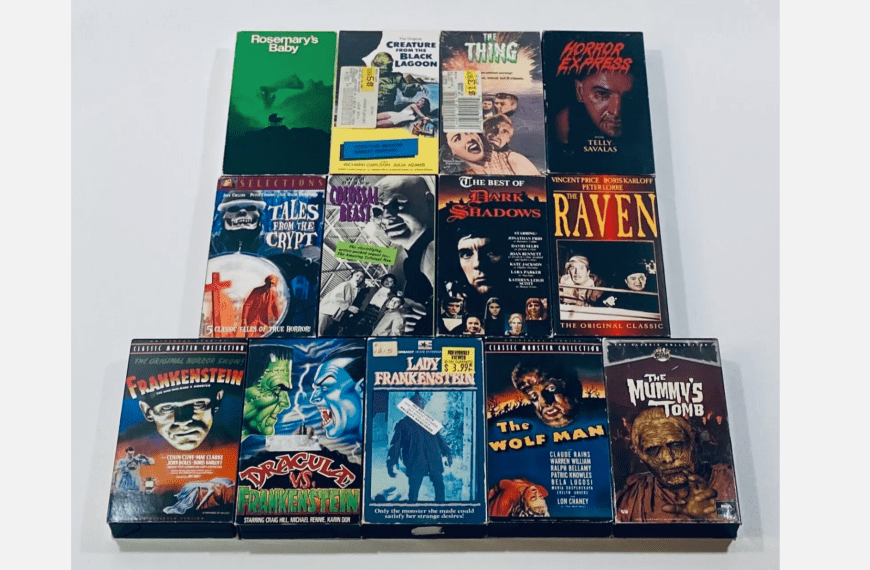 Collection of classic horror VHS tapes, titles include Rosemary’s Baby, The Thing, Frankenstein, The Wolf Man, The Mummy’s Tomb, displayed on white surface