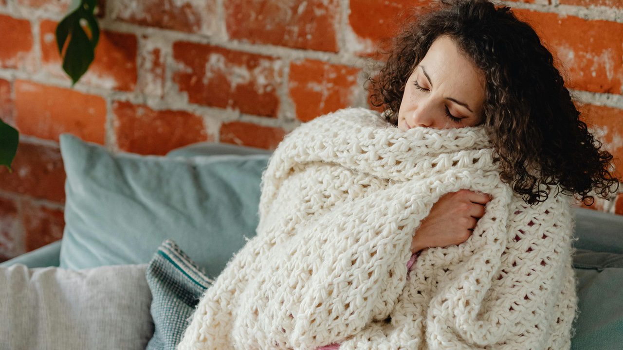 Woman with Blanket on Couch