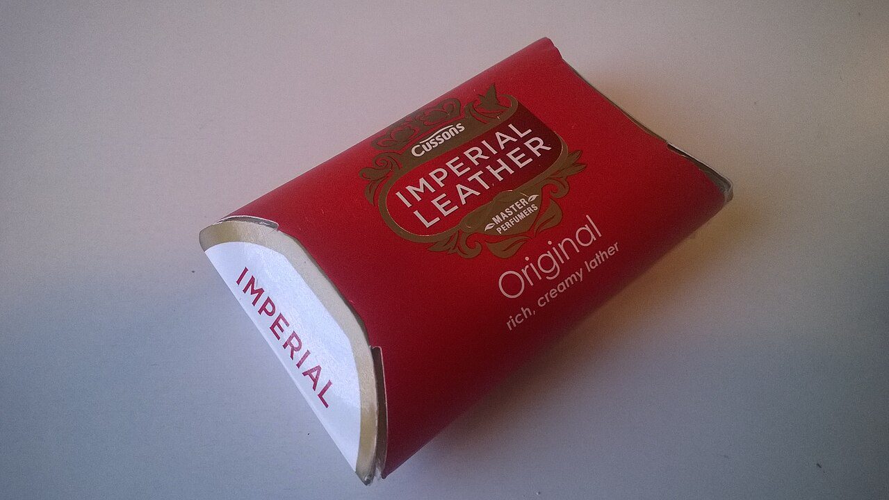 Red rectangular packaging of Cussons Imperial Leather soap, gold and white accents, labeled “Original,” tagline “rich, creamy lather,” placed on a plain white surface