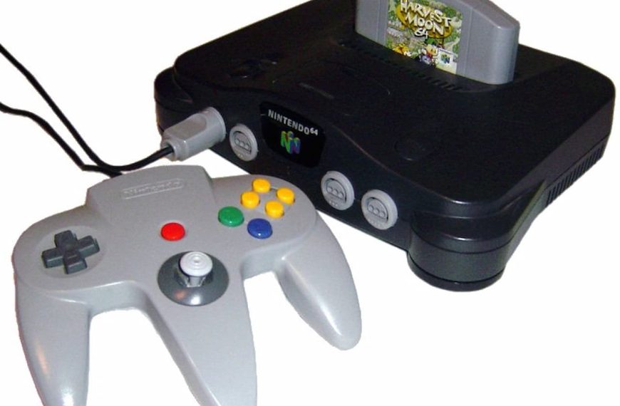 A Nintendo 64 console with a connected controller and a "Harvest Moon 64" game cartridge inserted in the slot