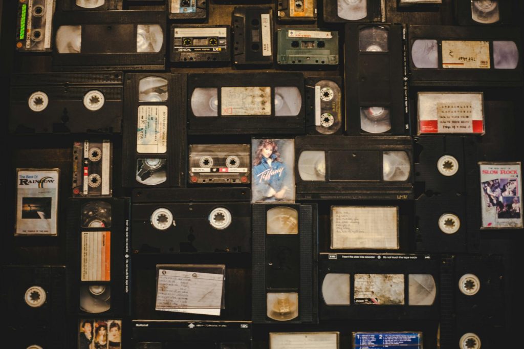 Collection of classic horror VHS tapes, titles include Rosemary’s Baby, The Thing, Frankenstein, The Wolf Man, The Mummy’s Tomb, displayed on white surface