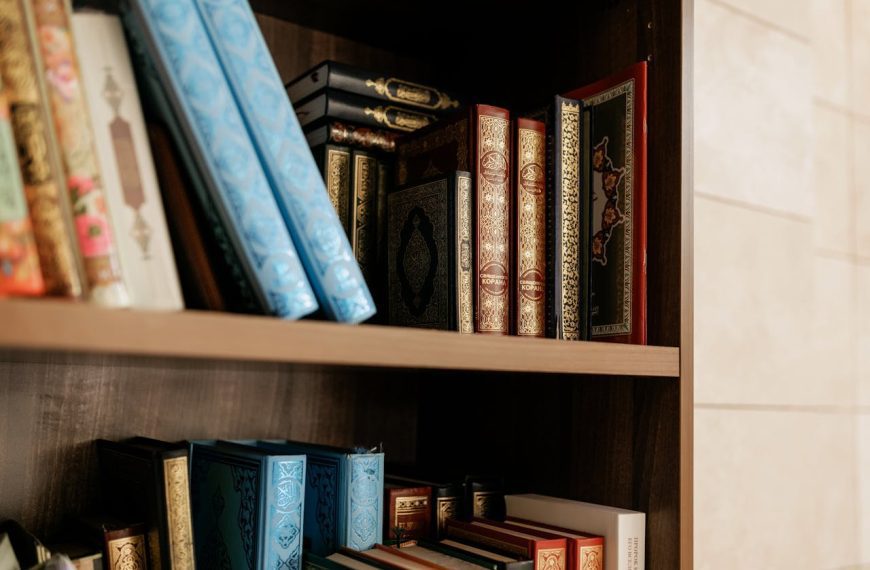 Wooden bookshelf with ornate military history books featuring gilded spines and colorful covers arranged on two shelves