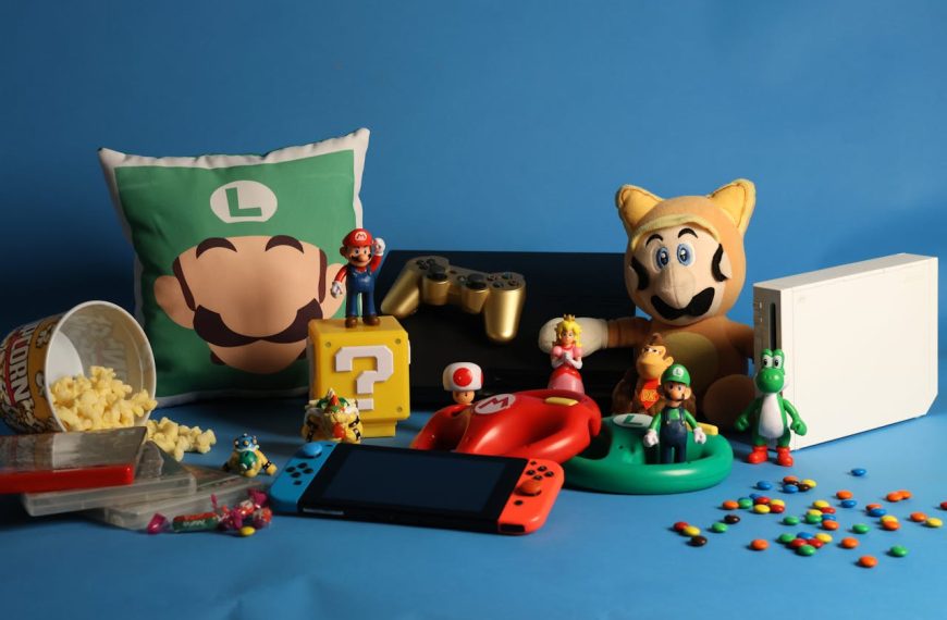 Assorted Super Mario-themed toys, figurines, and memorabilia on blue background, including Luigi pillow, Mario plush