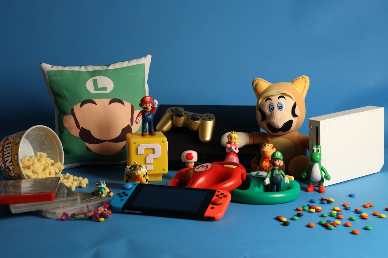 Assorted Super Mario-themed toys, figurines, and memorabilia on blue background, including Luigi pillow, Mario plush