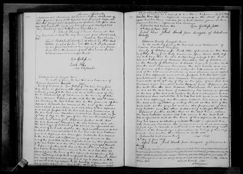 Open book with handwritten text on both pages, aged paper with visible ink markings, cursive writing in black ink, historical or archival document, possibly a journal or record book, photographed in black and white