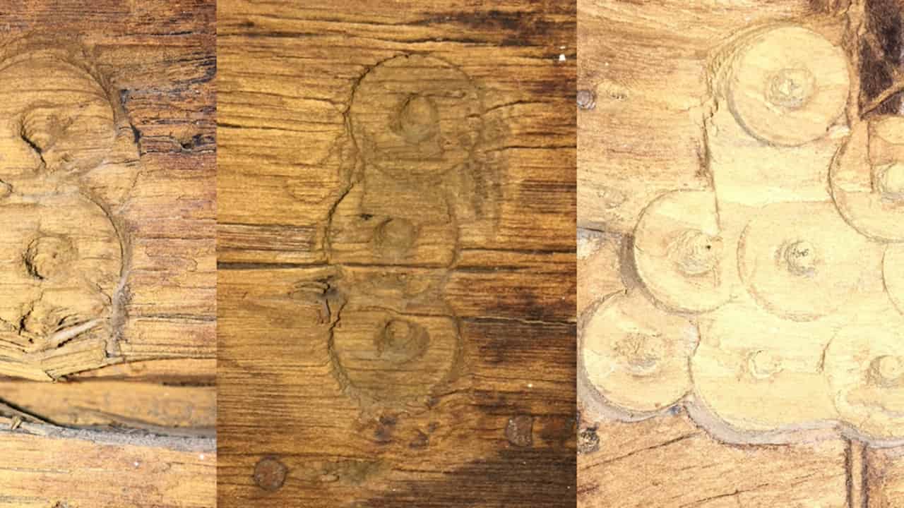 Three close-up images of circular carpenter's marks carved into wood, each showing varying groupings of concentric circles with central dots, resembling tally or joinery symbols