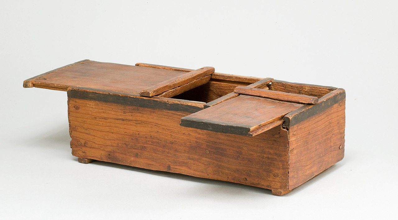 Wooden box with sliding compartments, rectangular shape, rustic finish, likely used for storage or organization, positioned on a white background