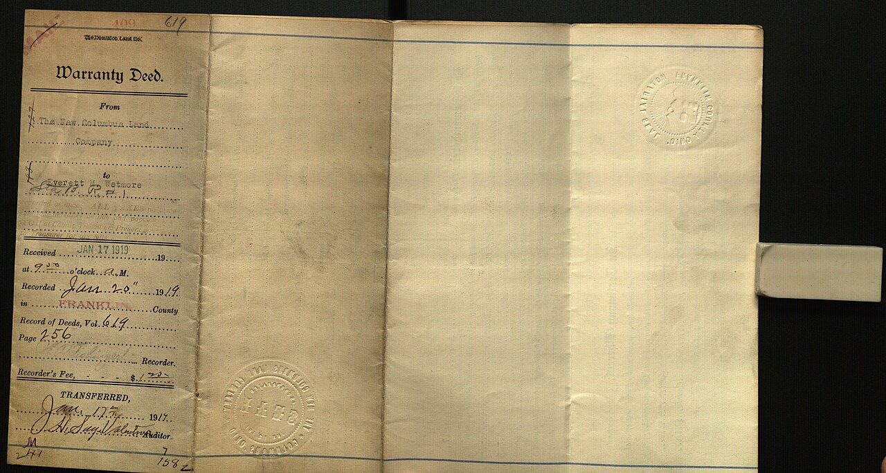 Aged handwritten document, folded parchment pages, visible text on left side, faded ink, archival record, historical manuscript, old legal or official record, bound spine on the right, preserved in controlled environment, possibly a will, ledger, or treaty.