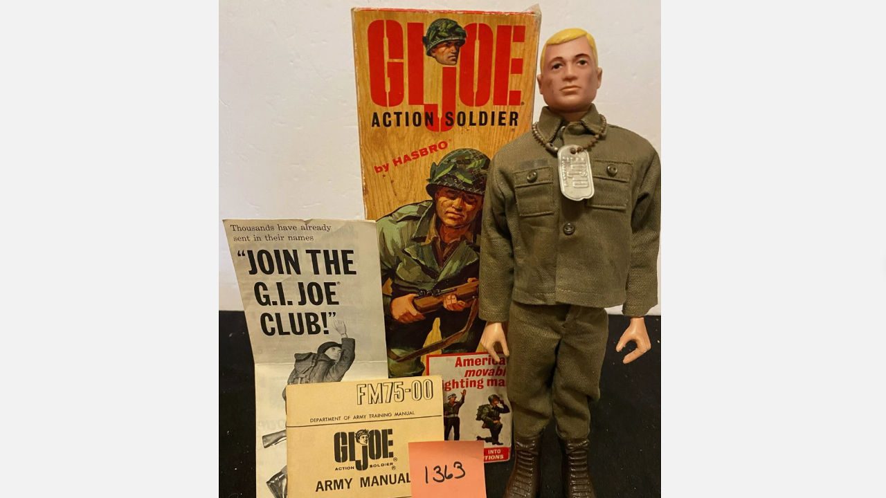 Vintage 1963 G.I. Joe action figure in army uniform with dog tags, surrounded by original packaging, army manual, and promotional club flyer