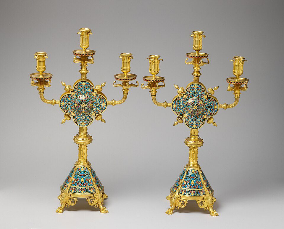 Pair of ornate gold candelabras, three candle holders on each, detailed turquoise enamel accents, intricate decorative design