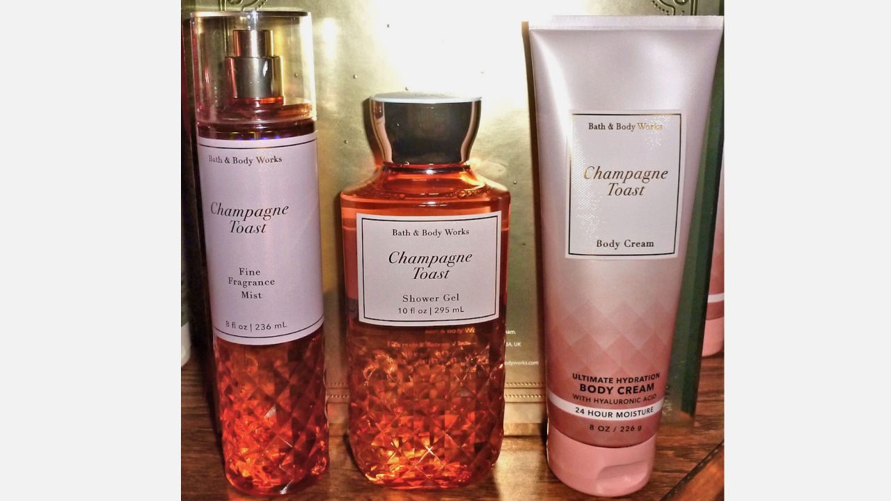 Three Bath & Body Works “Champagne Toast” products displayed side by side on a wooden surface