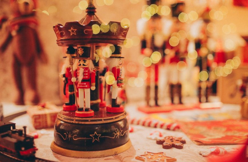 Nutcracker figurines on display, vibrant holiday decor, red and gold color theme, festive table setting