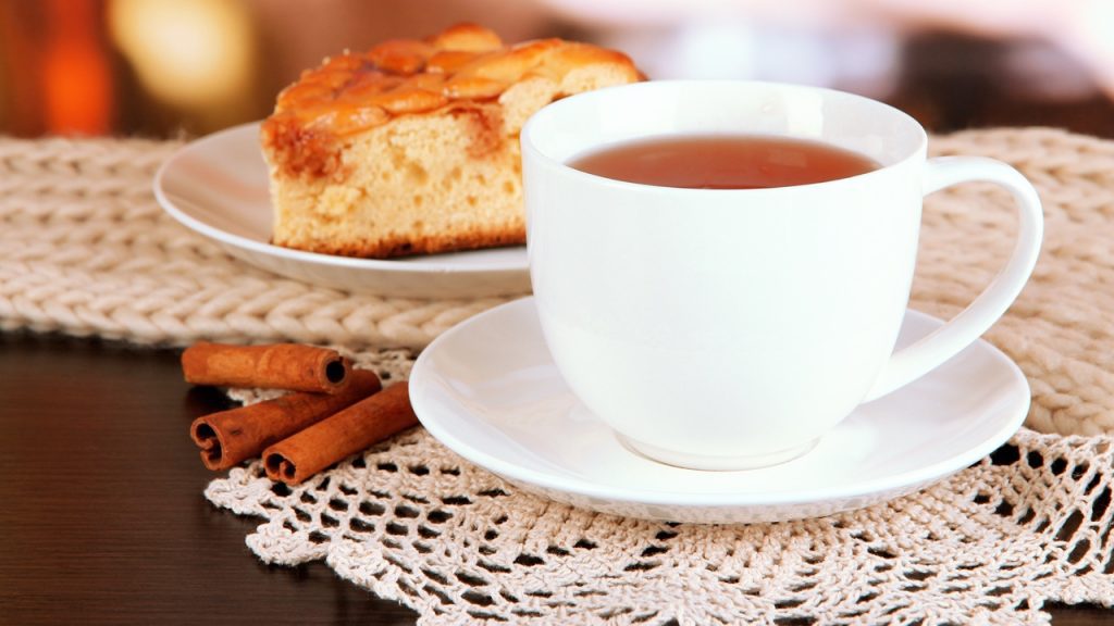 A cup of tea on a white lace doily