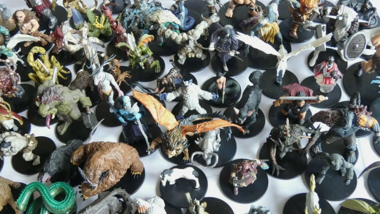 Assorted Dungeons & Dragons miniatures on black bases, featuring a variety of creatures, monsters, heroes, and mythical beings in dynamic poses
