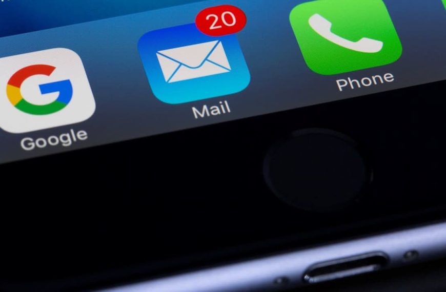 Close-up of a smartphone screen showing unread email notification, Google, Mail, Phone, and WhatsApp app icons