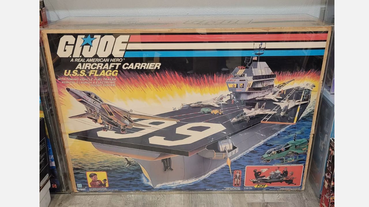 Boxed G.I. Joe U.S.S. Flagg aircraft carrier playset, featuring artwork of a large toy ship with jets and accessories