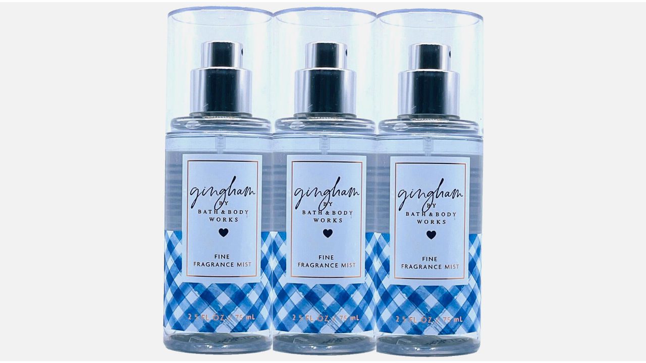 Three bottles of Gingham fine fragrance mist by Bath & Body Works, transparent bottles with blue plaid design and clear caps