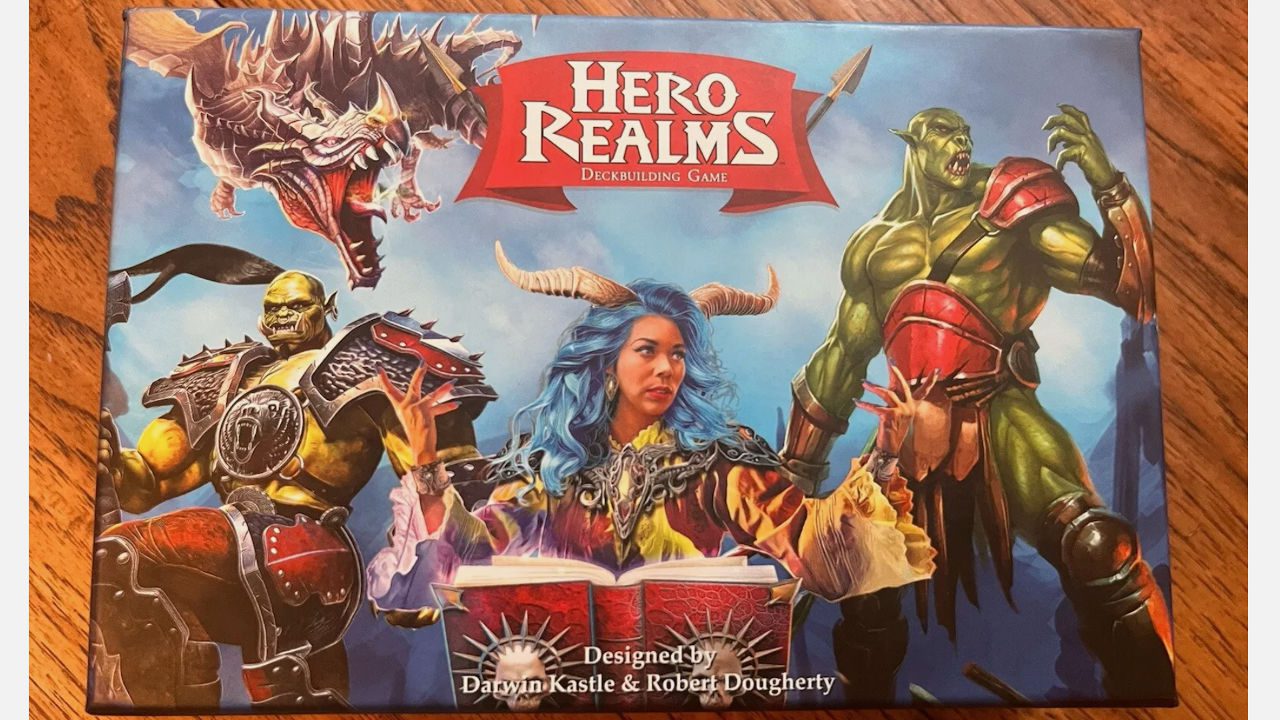 Hero Realms deck-building game cover art featuring a fierce horned sorceress with glowing eyes at the center