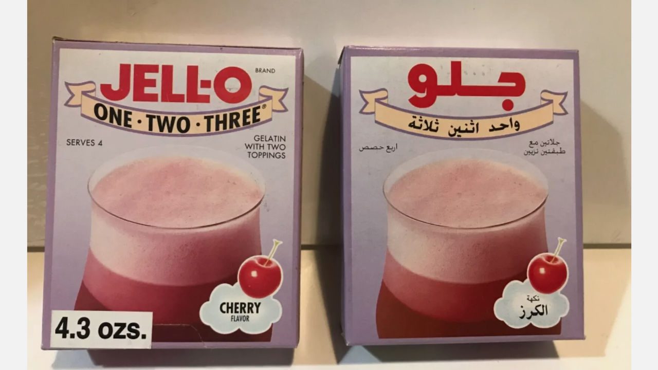 Two boxes of Jell-O One-Two-Three cherry gelatin dessert, one in English and one in Arabic, both showing a layered cherry gelatin treat