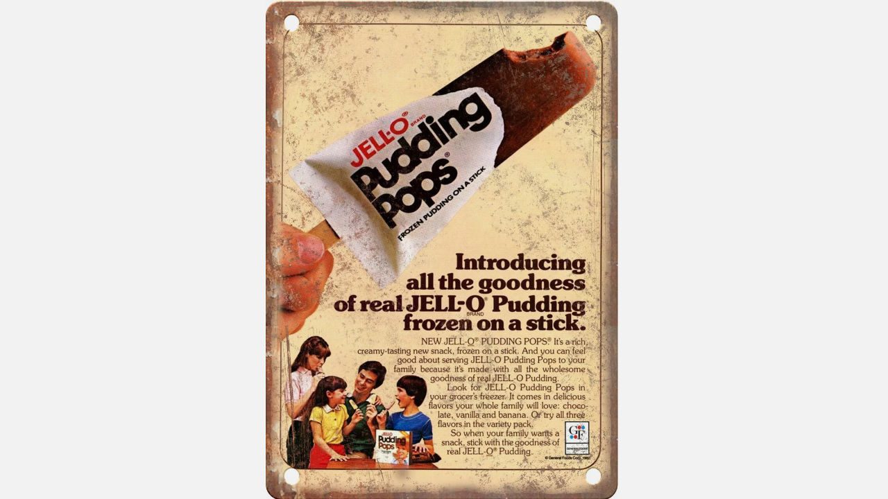Retro JELL-O Pudding Pops ad showing hand holding chocolate pop, tagline "Introducing all the goodness of real JELL-O Pudding frozen on a stick"