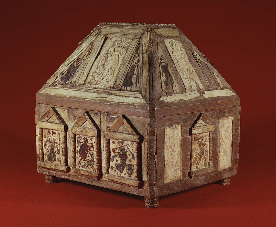 Wooden reliquary box, pyramid-shaped top, decorated with religious iconography, detailed painted panels on all sides, aged wood finish