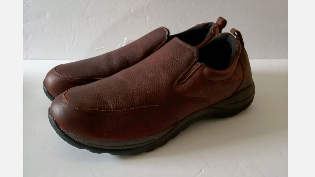 Pair of brown leather L.L.Bean Comfort Mocs with black rubber soles on a white background