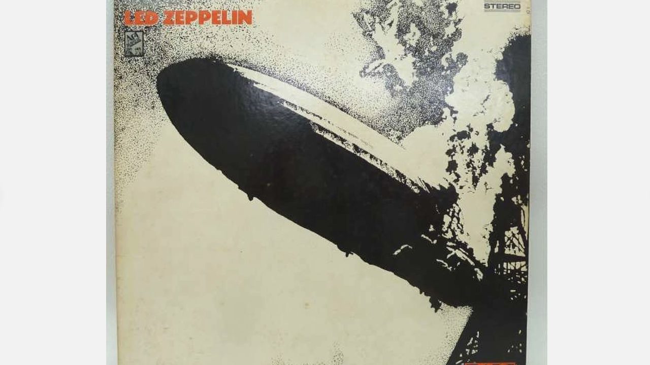 Led Zeppelin debut album cover, black and white Hindenburg disaster image with "LED ZEPPELIN" in turquoise lettering, early pressing