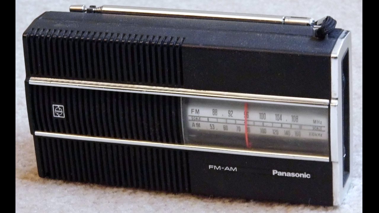 Vintage black Panasonic AM/FM radio with horizontal tuning dial, silver detailing, and pull-up antenna