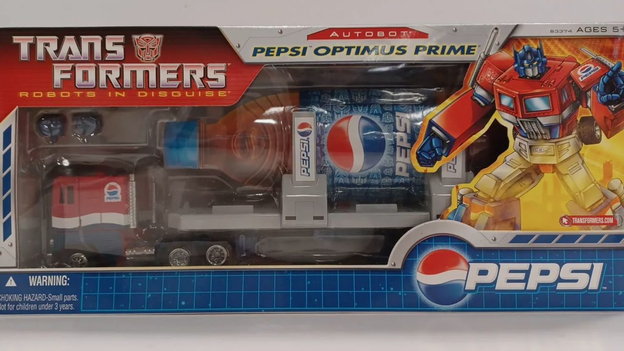 Pepsi Optimus Prime collectible in original packaging, featuring a red and blue truck cab with a Pepsi-branded trailer and Autobot artwork