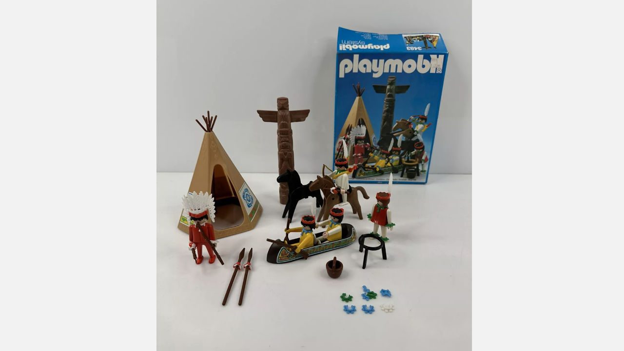 Vintage Playmobil Native American-themed playset with tipi, canoe, figures, animals, accessories, and original blue box