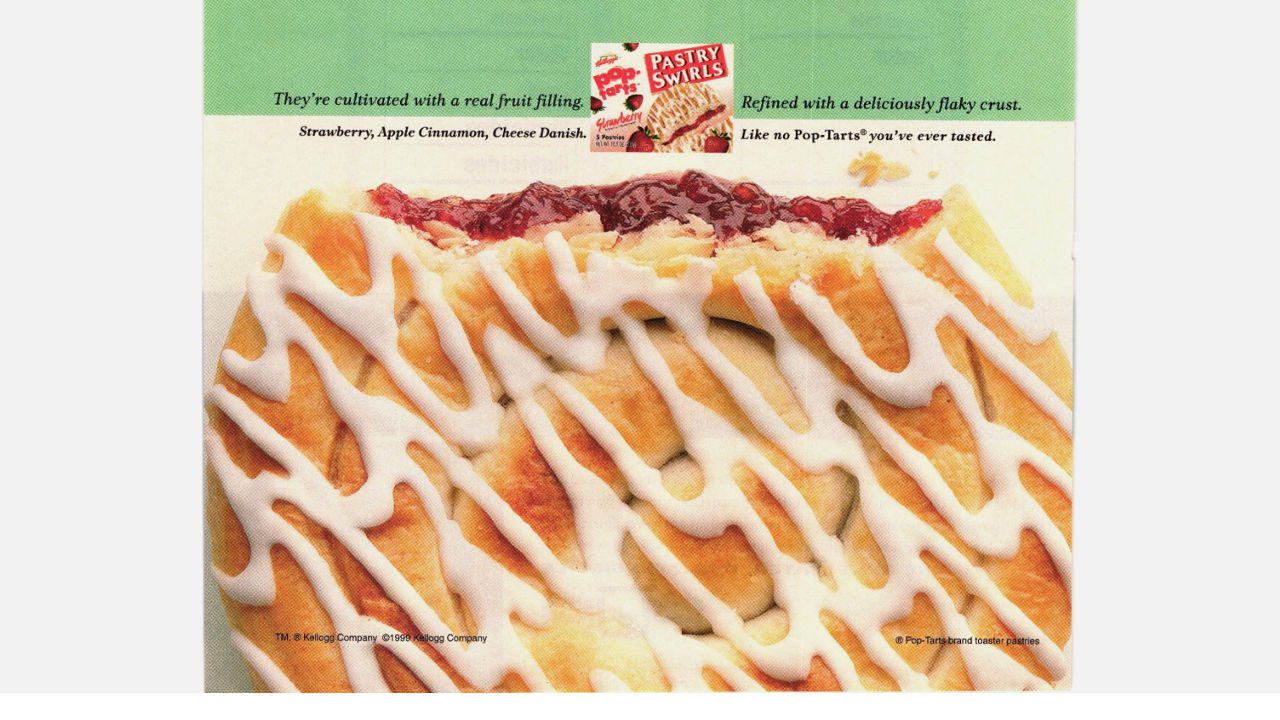 Close-up of Pop-Tarts Pastry Swirls with flaky crust, white icing drizzle, and visible strawberry filling on top