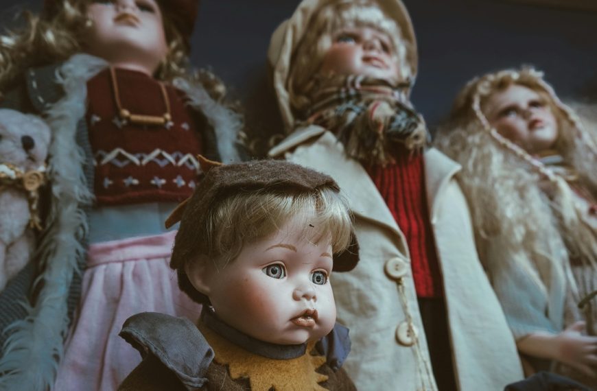 Porcelain Dolls, Group of vintage porcelain dolls, dressed in old-fashioned winter clothes, blank expressions, dramatic lighting