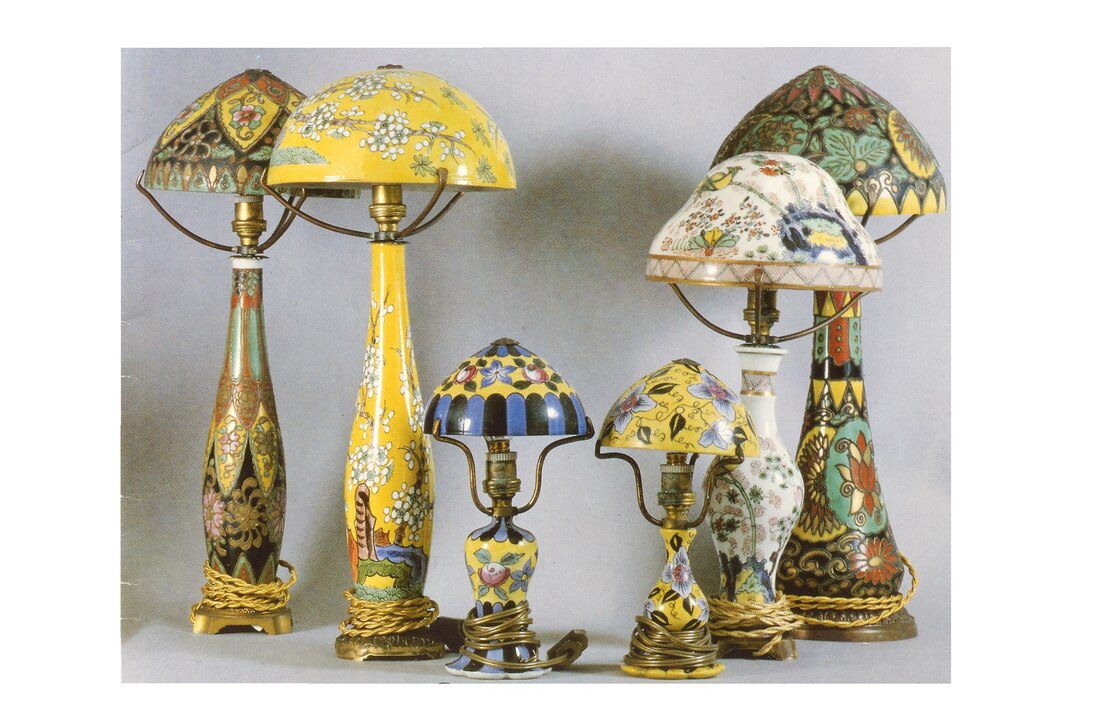 Antique-style table lamps, stained glass shades, ornate decorative bases, various sizes and designs, arranged in a group display, vintage and artistic look, colorful and intricate detailing