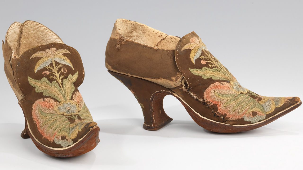 Historical fashion exhibit, 18th-century aristocratic footwear, antique costume collection, museum artifact documentation,