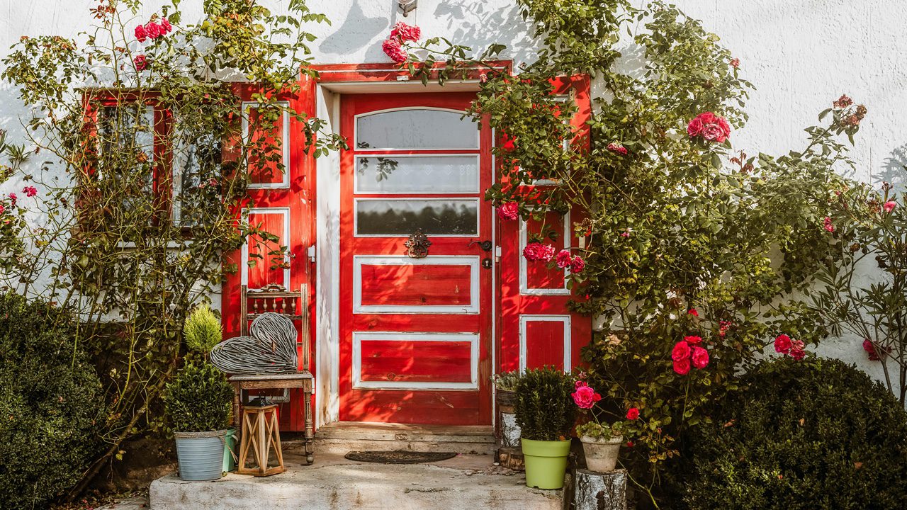 Bold, red front door. Porch